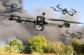 Рой дронов над лесом на закате